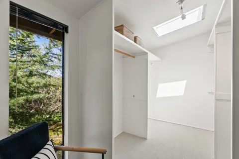 a bathroom with a sink mirror and window