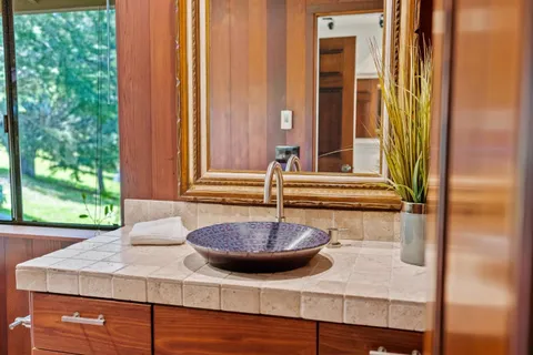 a view of a balcony a bath tub and door