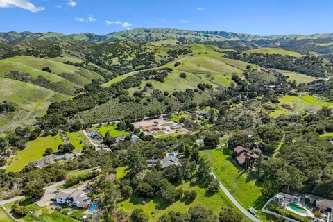 an aerial view of a house with a yard