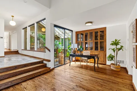 a living room filled with furniture hardwood floor and a large window