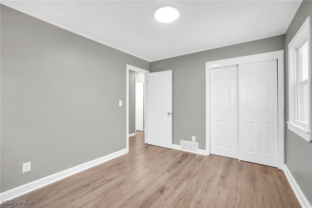3930 Wadsworth Road Barberton, OH 44203 - Photo 20 of 30 Unfurnished bedroom featuring light wood-style floors and a closet