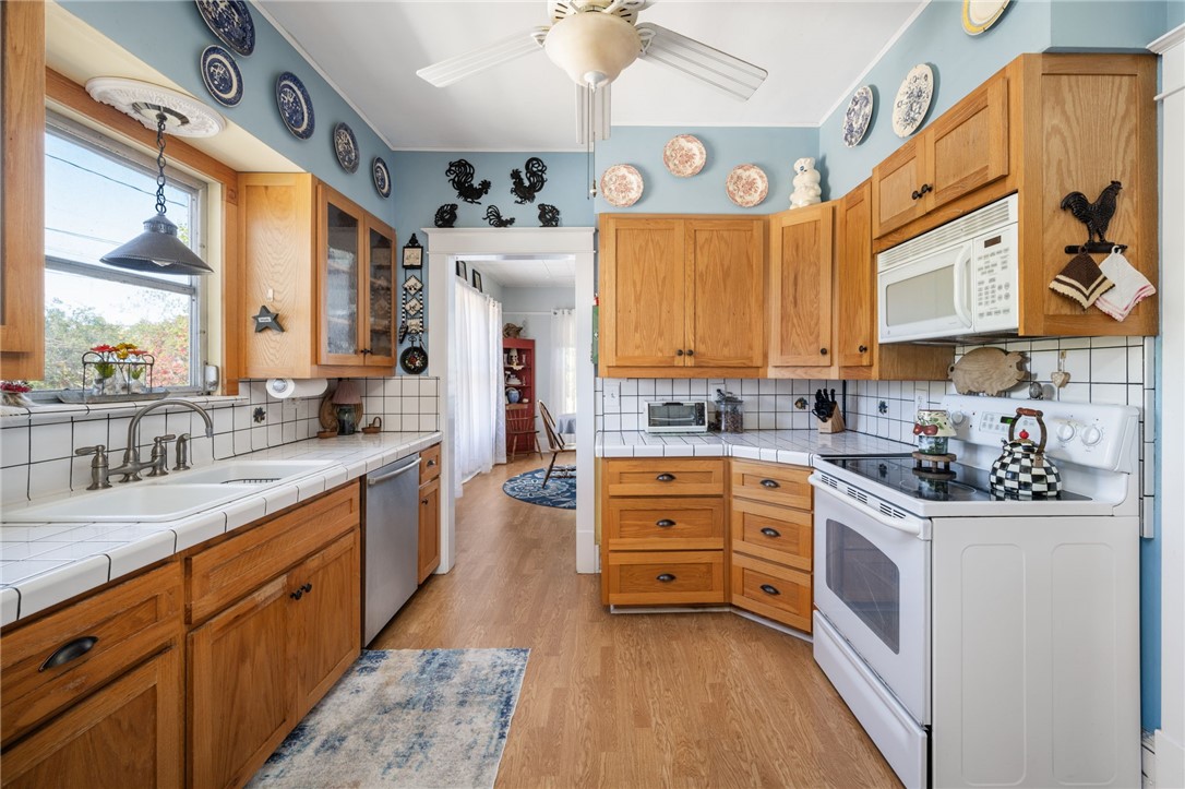9115 Highway 1 Sebastian, FL 32958 - Photo 15 of 34 a large kitchen with stainless steel appliances granite countertop a stove a sink dishwasher and cabinets with wooden floor