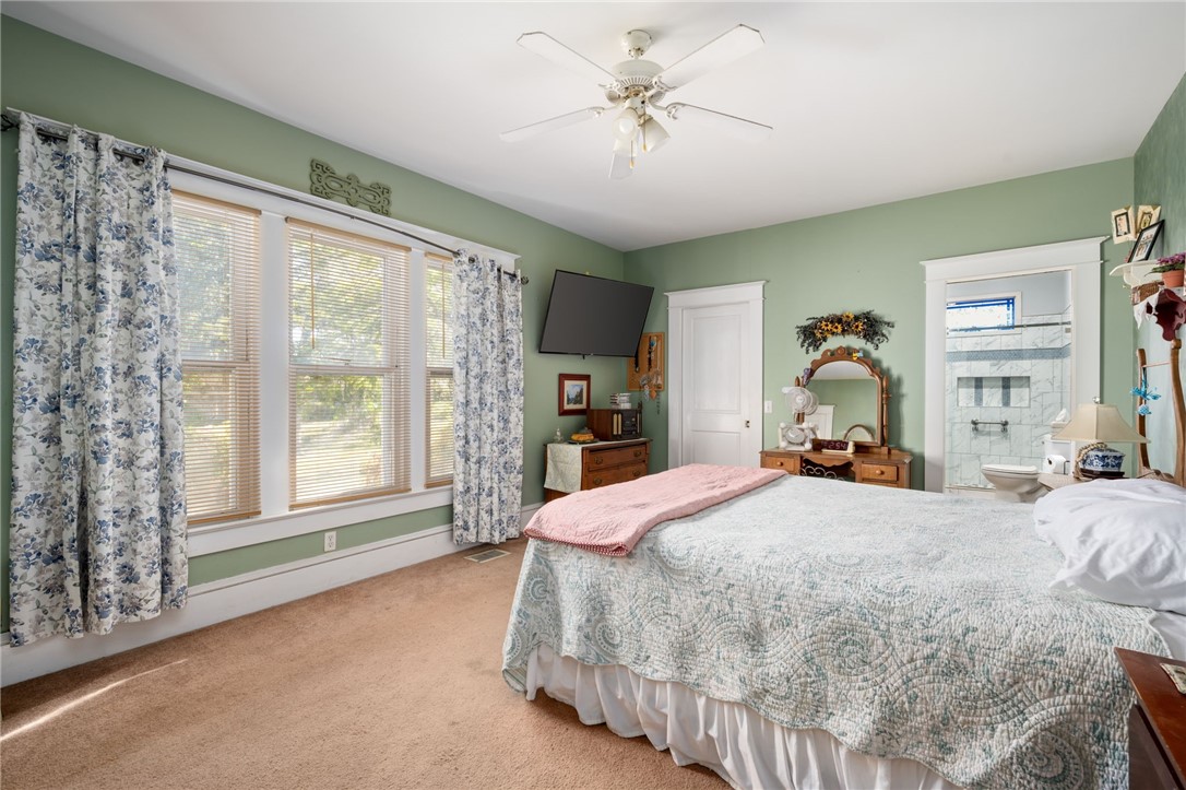 9115 Highway 1 Sebastian, FL 32958 - Photo 17 of 34 a bedroom with a large bed and a chandelier