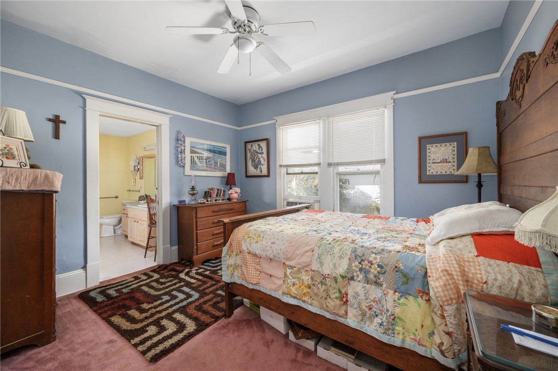 9115 Highway 1 Sebastian, FL 32958 - Photo 20 of 34 a bedroom with a bed and a chandelier