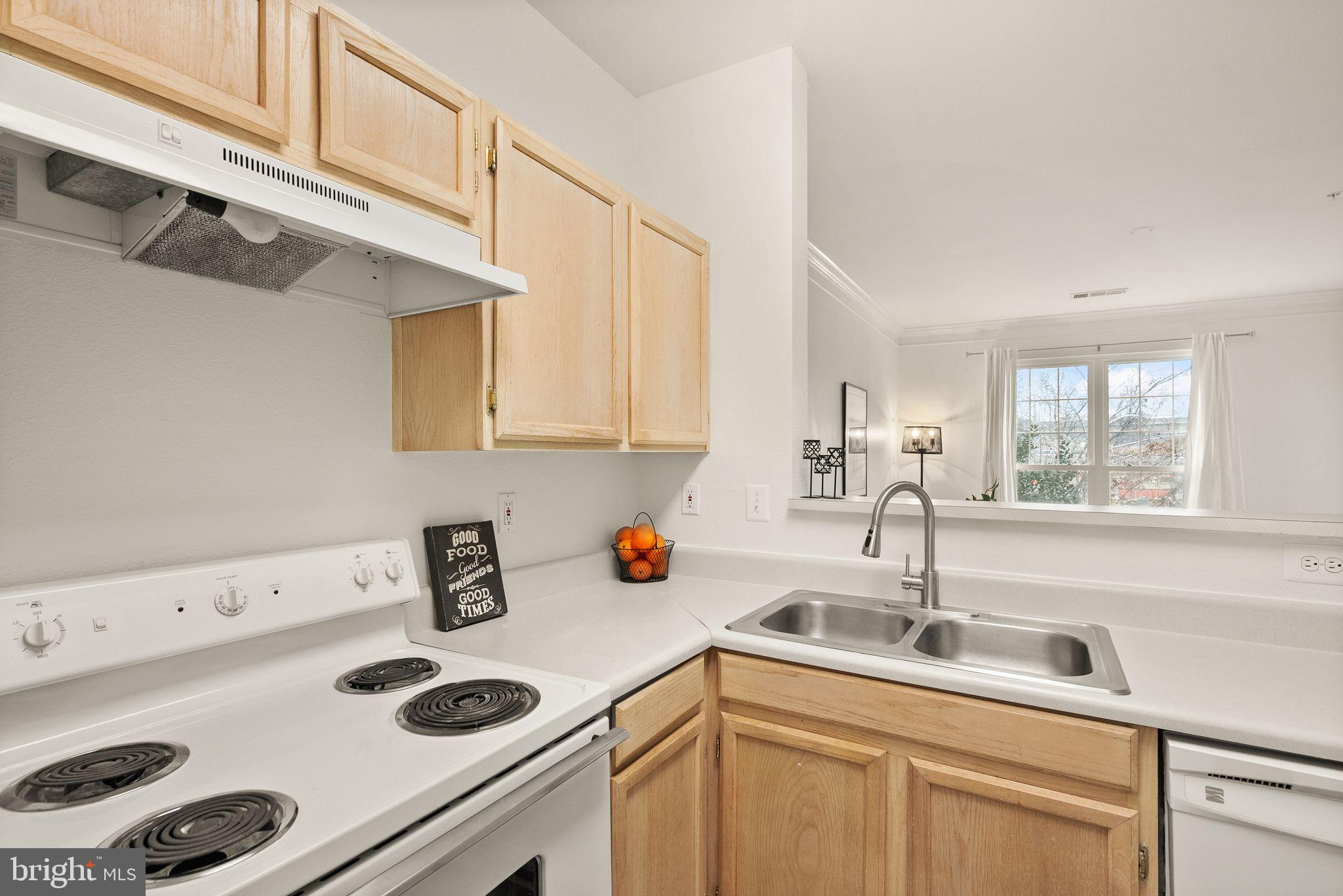 1601 Spring Gate Dr., Unit 1116 McLean, VA 22102 - Photo 13 of 26 a kitchen with a sink a stove and cabinets