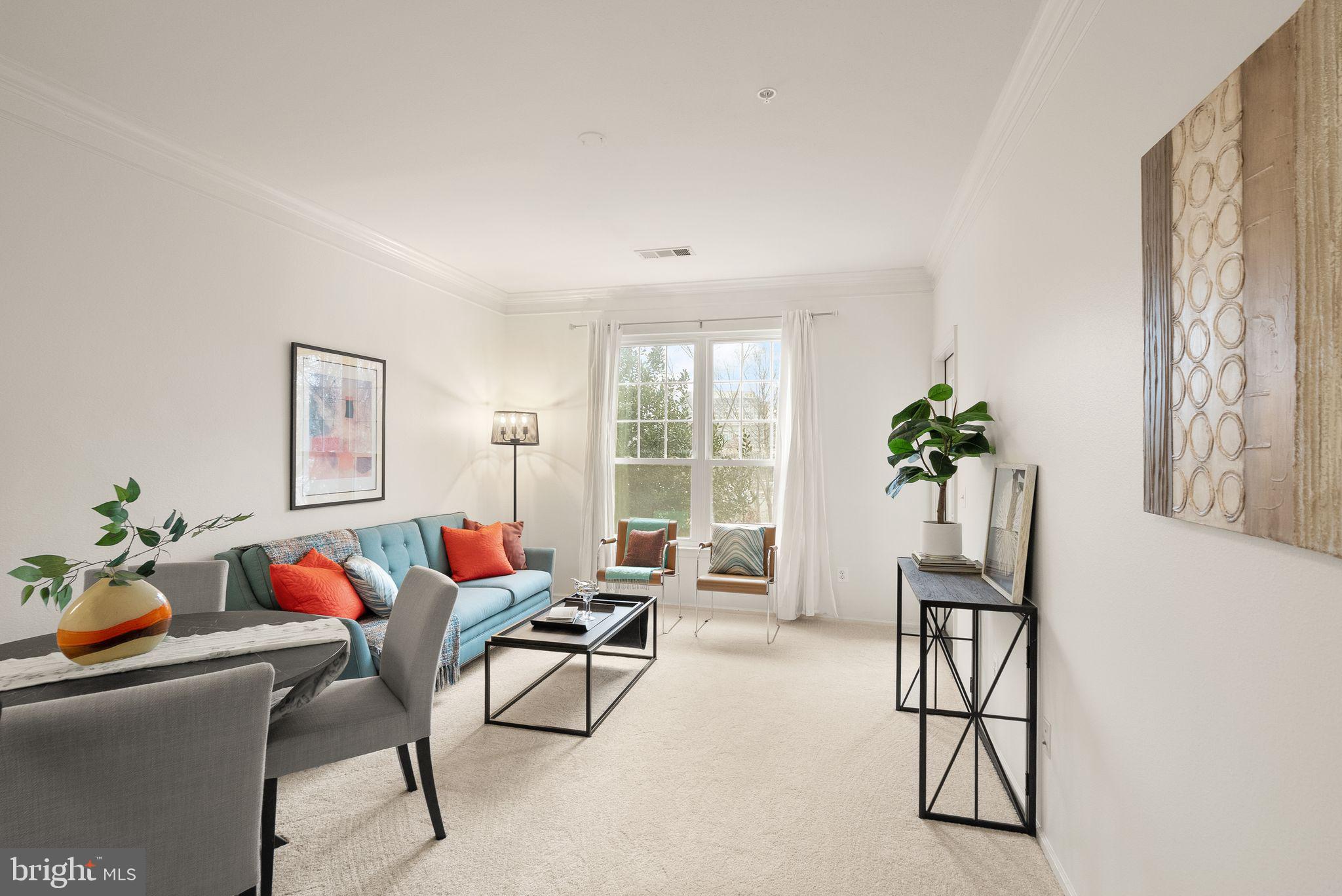 1601 Spring Gate Dr., Unit 1116 McLean, VA 22102 - Photo 15 of 26 a living room with furniture flowers and a window