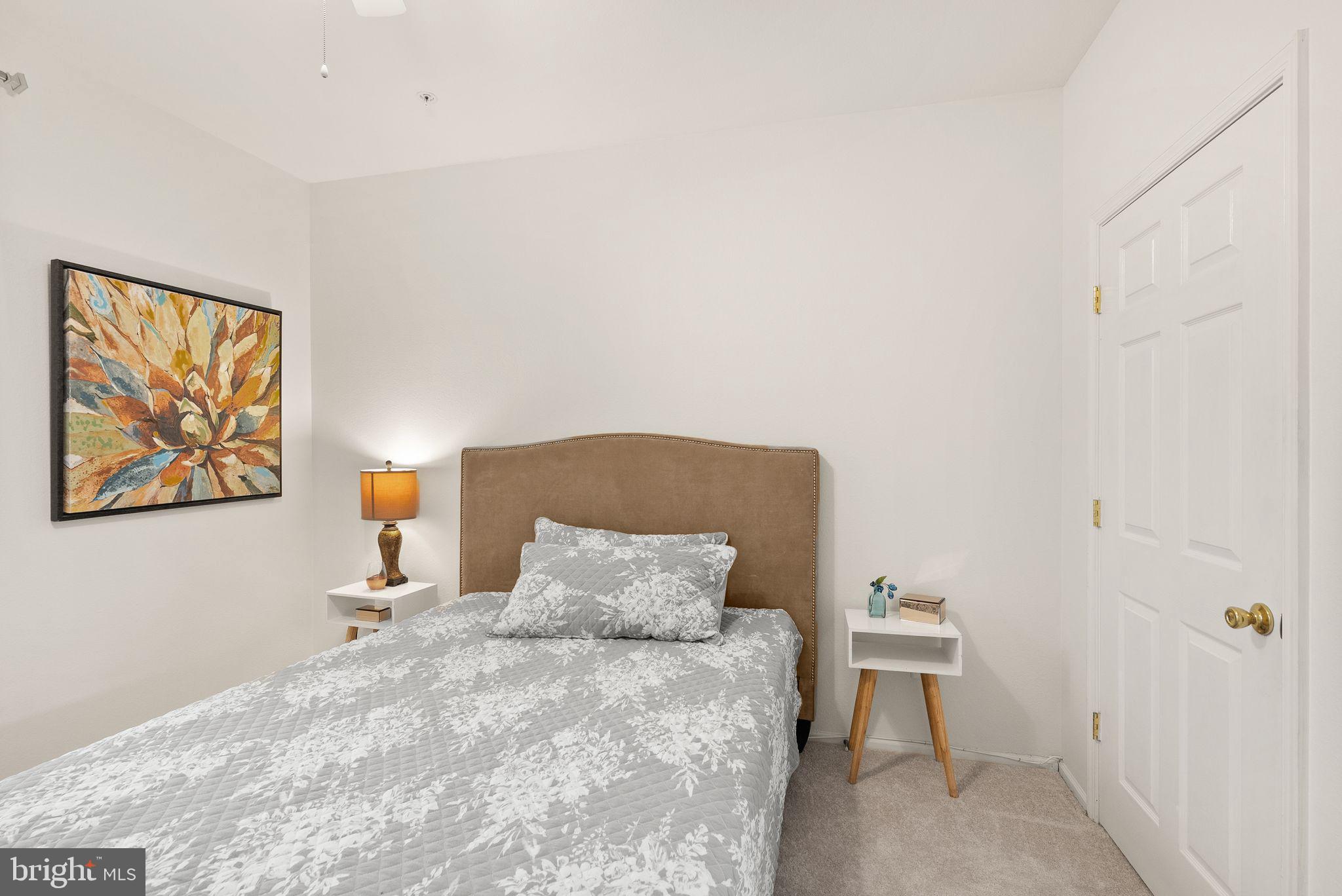 1601 Spring Gate Dr., Unit 1116 McLean, VA 22102 - Photo 18 of 26 a bedroom with a bed and a painting on the wall