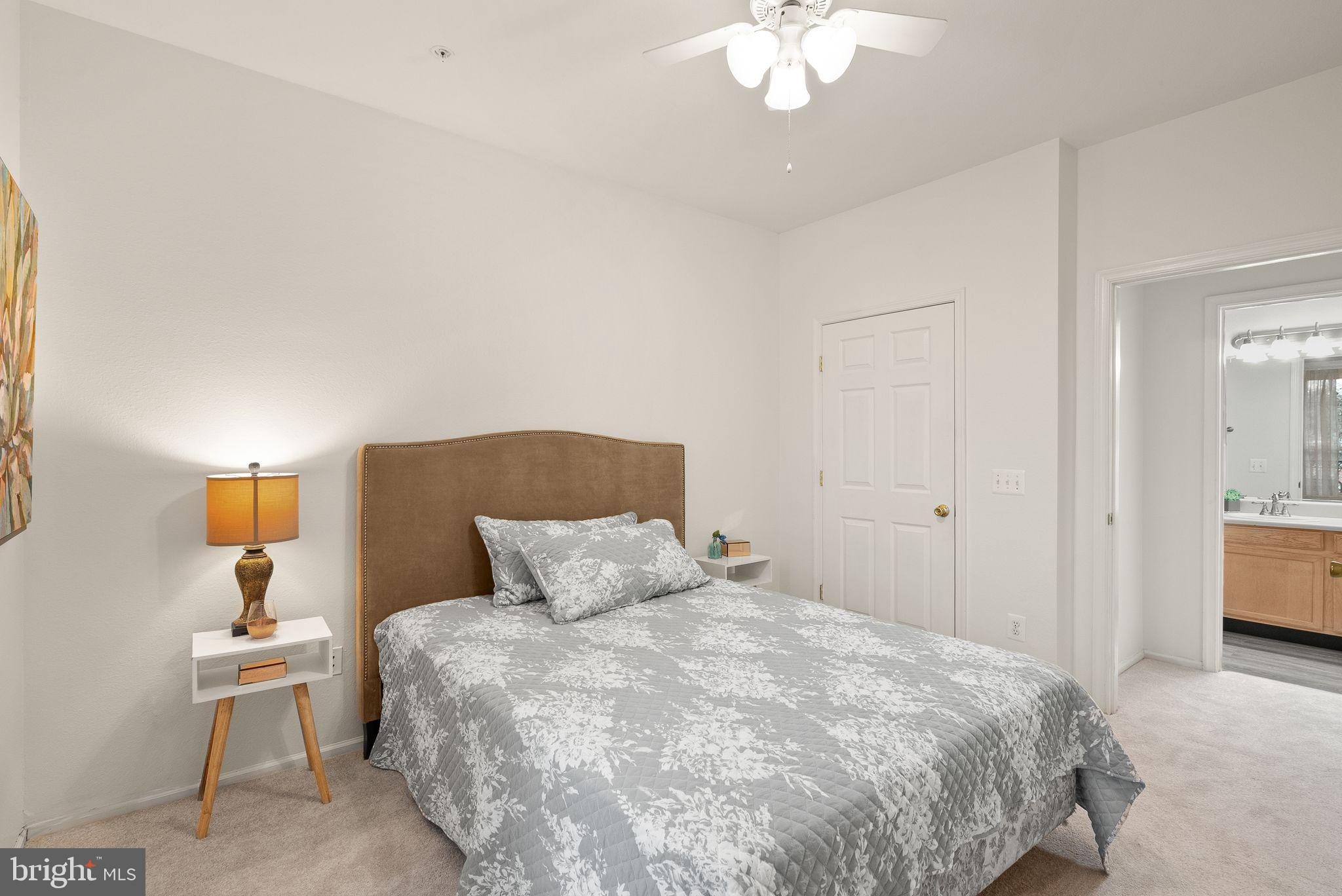 1601 Spring Gate Dr., Unit 1116 McLean, VA 22102 - Photo 19 of 26 a bedroom with a bed and a chandelier
