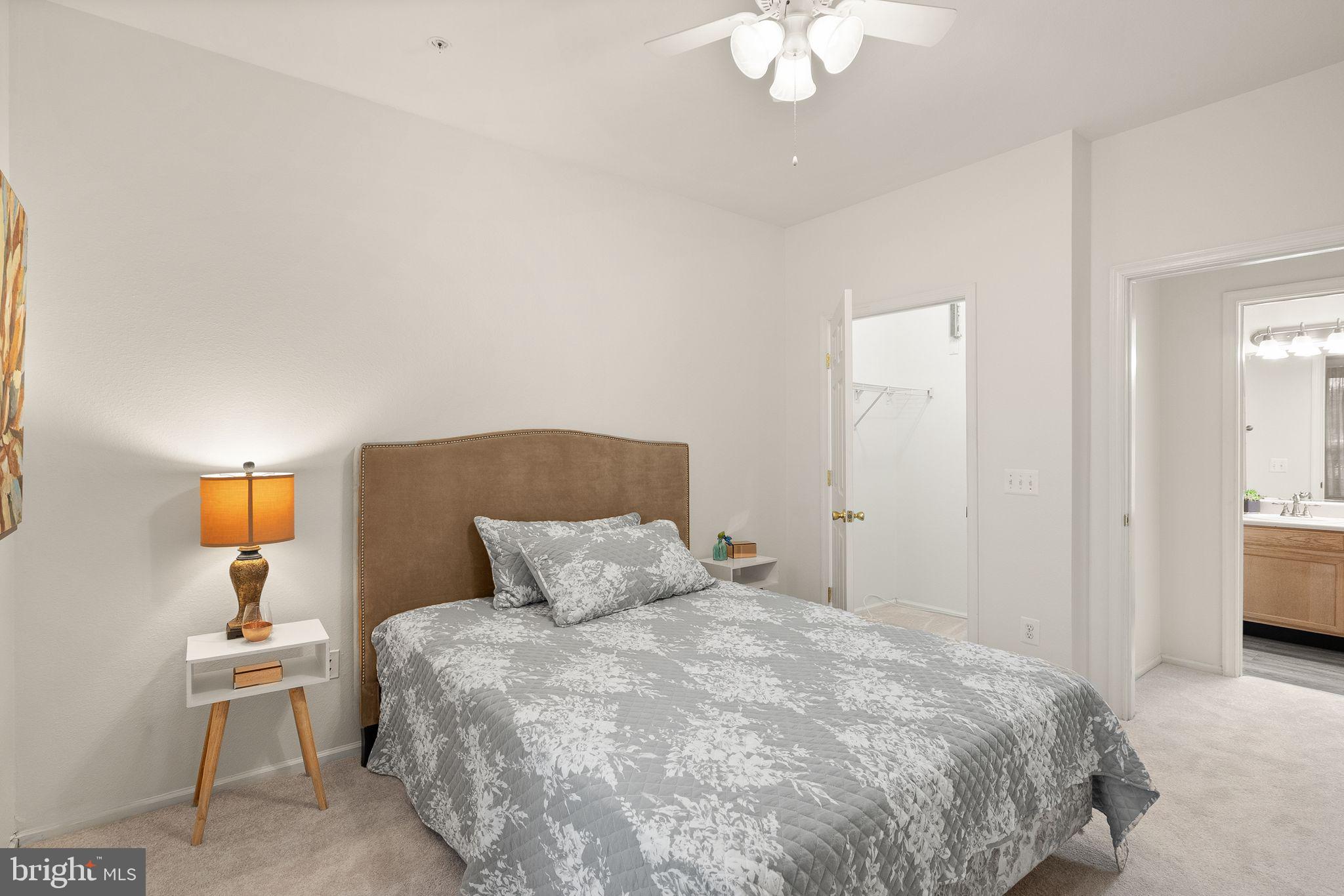 1601 Spring Gate Dr., Unit 1116 McLean, VA 22102 - Photo 20 of 26 a bedroom with a bed and a chandelier