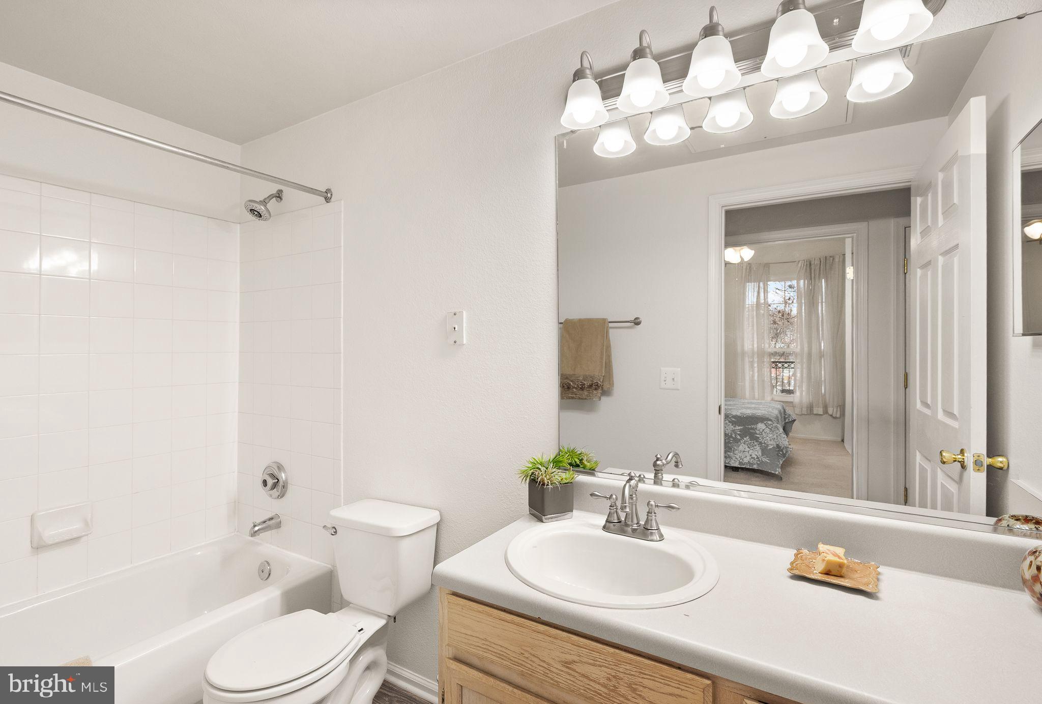 1601 Spring Gate Dr., Unit 1116 McLean, VA 22102 - Photo 22 of 26 a bathroom with a sink a toilet and a mirror