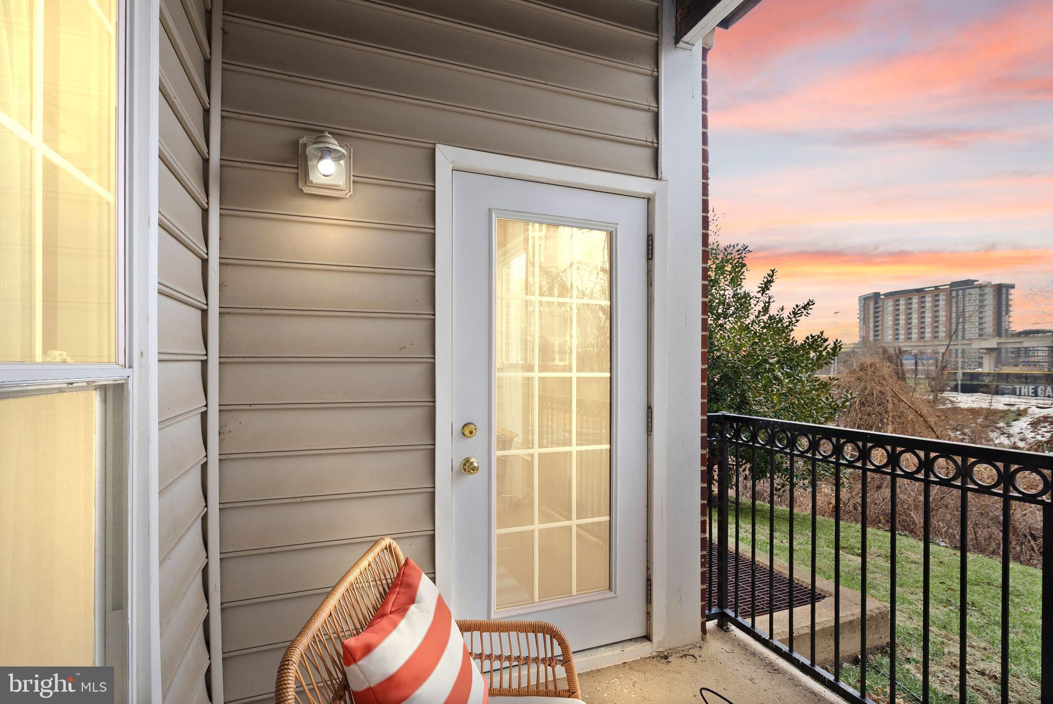 1601 Spring Gate Dr., Unit 1116 McLean, VA 22102 - Photo 6 of 26 a view of a balcony with wooden floor and iron fence