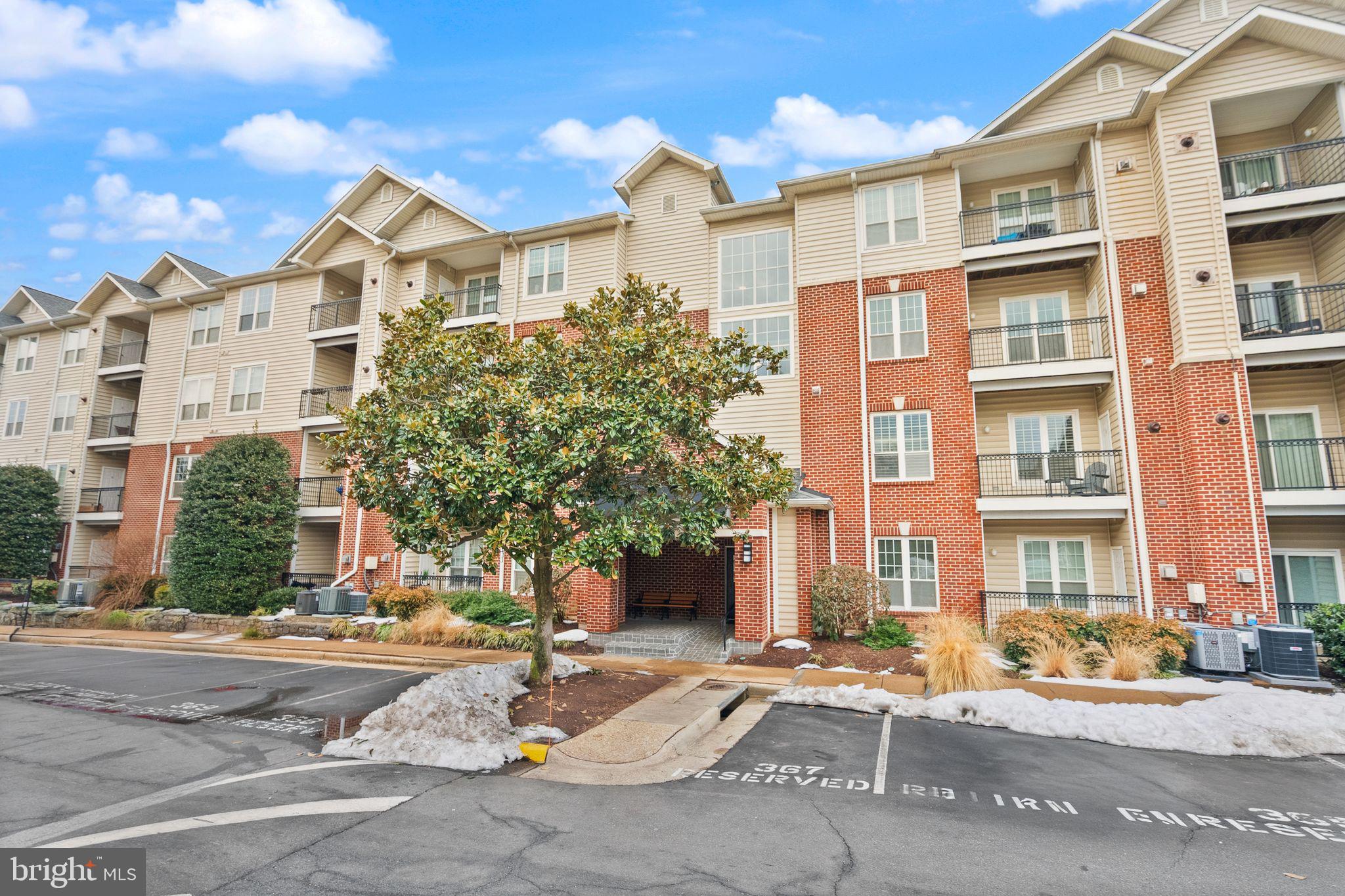 1601 Spring Gate Dr., Unit 1116 McLean, VA 22102 - Photo 8 of 26 a front view of a residential apartment building with a yard