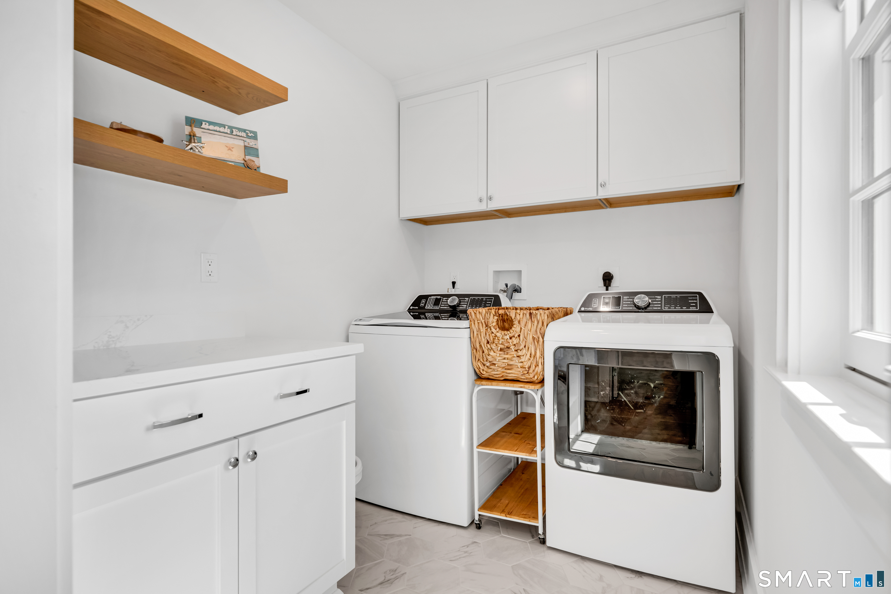 920 Old Post Road Fairfield, CT 06824 - Photo 30 of 40 Fantastic laundry room with tons of storage space and pocket door