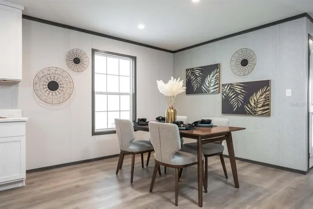 a dining room with wooden floor and a window