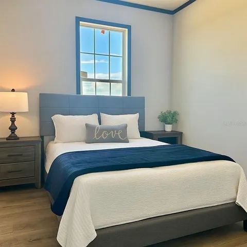 a bedroom with bed and window