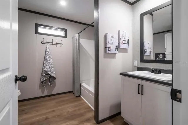 a bathroom with a sink a mirror and shower