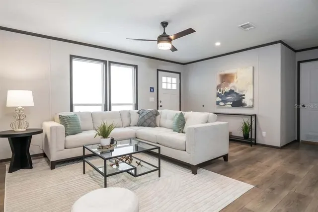 a living room with furniture and a large window