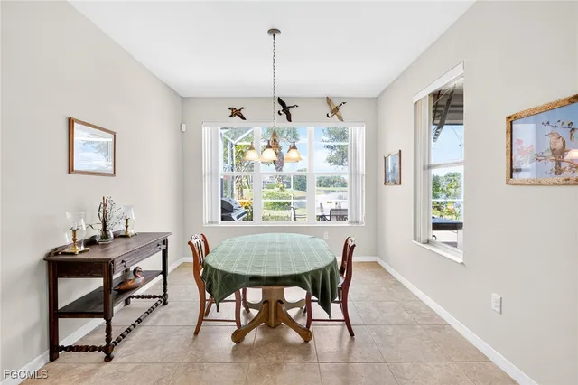 a dining room with kitchen island a table and chairs