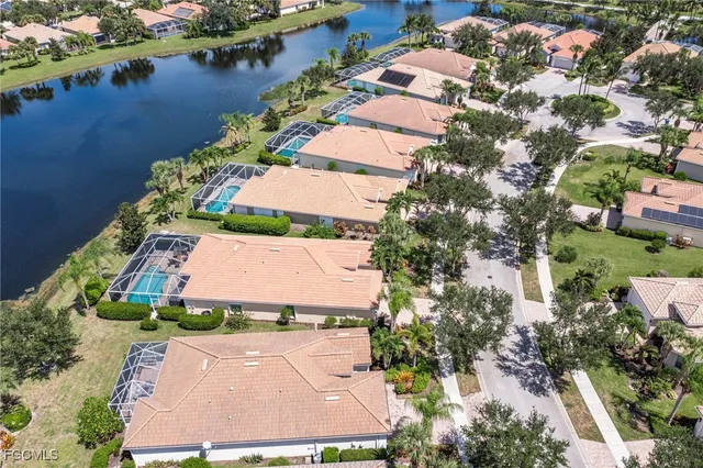 an aerial view of a house with a garden and lake view