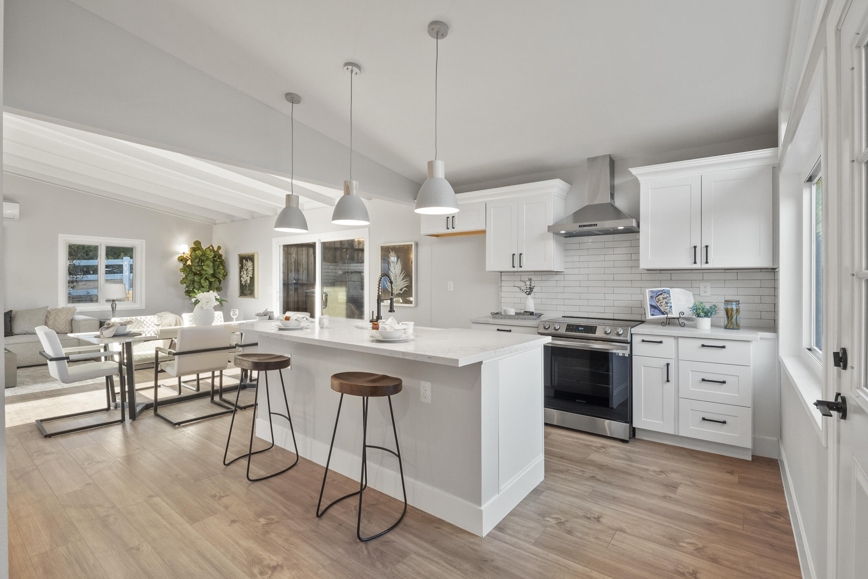 1530 Crestview Trail Acton, CA 93510 - Photo 17 of 43 a kitchen with stainless steel appliances granite countertop a stove a sink dishwasher a refrigerator and white cabinets with wooden floor