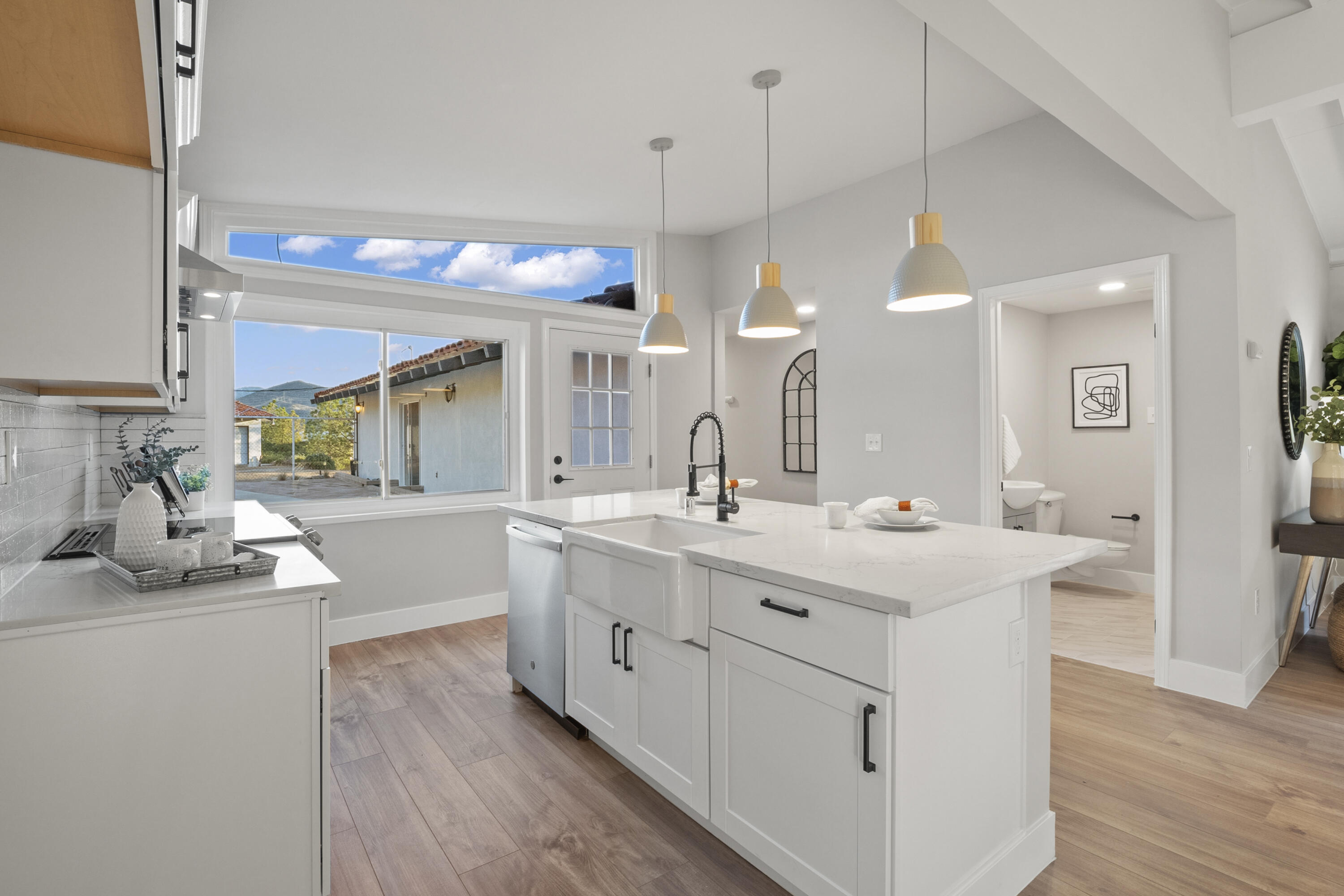 1530 Crestview Trail Acton, CA 93510 - Photo 19 of 43 a large white kitchen with a lot of counter space and wooden floor