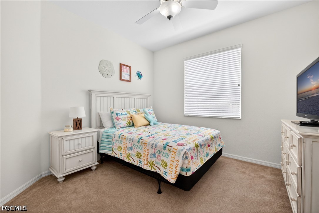 8251 Pathfinder Loop, Unit 621 Fort Myers, FL 33919 - Photo 21 of 30 a bedroom with a bed and a tv on the dresser