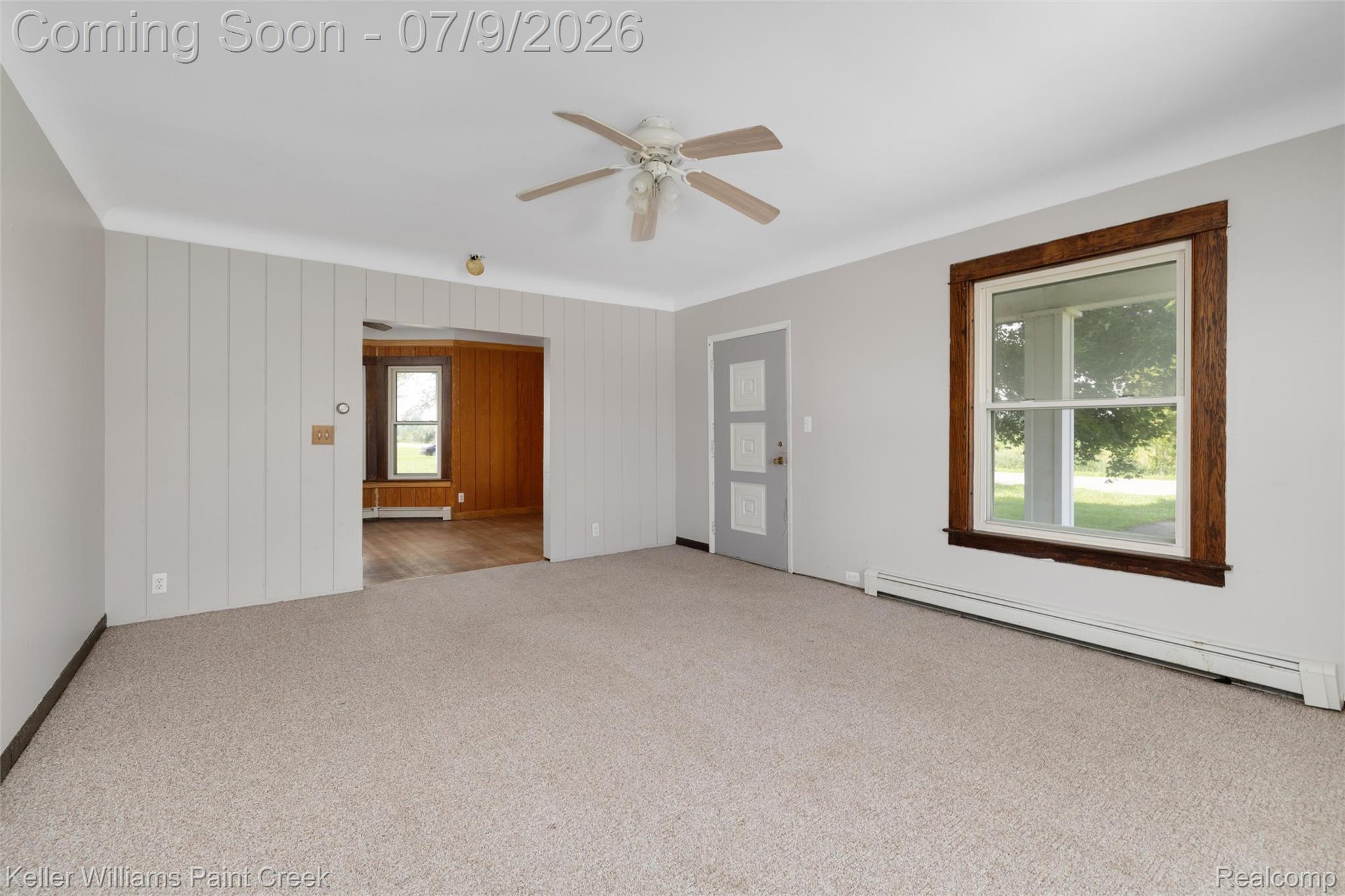 28780 School Section Road Richmond, MI 48062 - Photo 5 of 50 Spacious room featuring light-toned carpet, a ceiling fan, and a large window with dark wood trim
