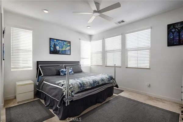 a bed sitting in a bedroom next to a window