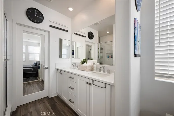 a bathroom with a sink a mirror and a shower