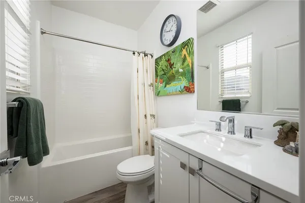 a bathroom with a sink a toilet and a shower