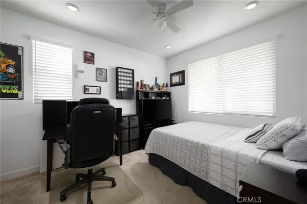 a bedroom with a bed and a desk