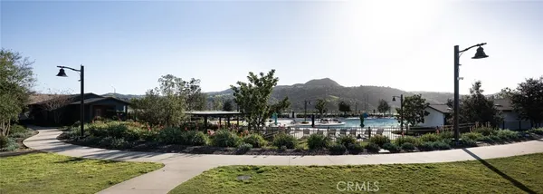 a view of a street with a house in the background