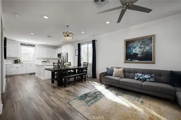 a living room with furniture and kitchen view