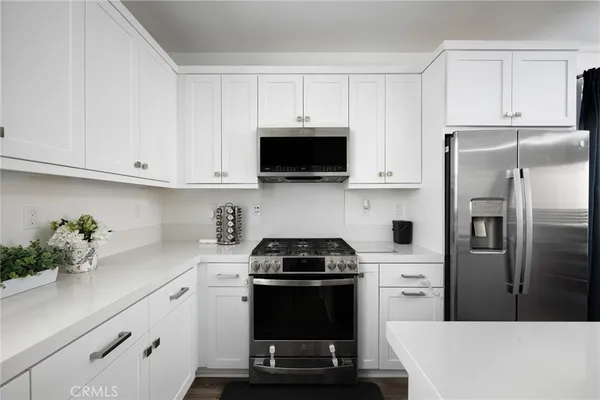 a kitchen with a stove and a refrigerator