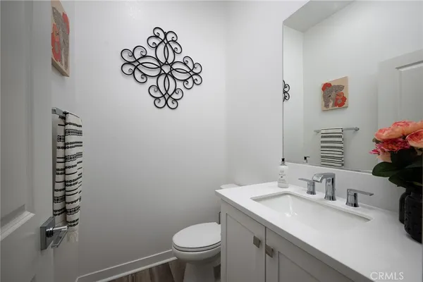 a bathroom with a sink mirror vanity and toilet