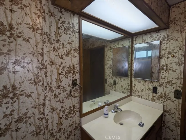 a bathroom with a sink and a mirror