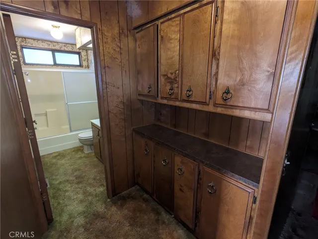 a kitchen with a stove a refrigerator and cabinets