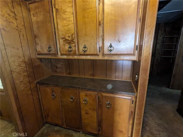 a large kitchen with stainless steel appliances a stove and a refrigerator