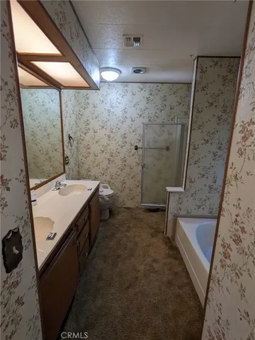 a backyard of a house with yard table and chairs