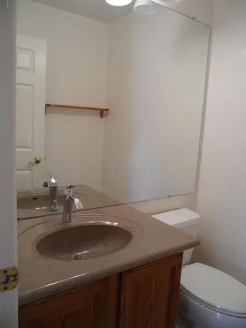 a bathroom with a sink toilet and mirror
