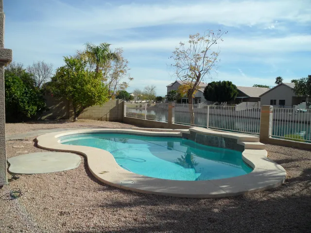 a view of a swimming pool with a yard