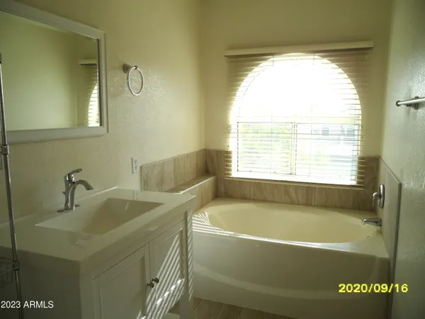 a bathroom with a bathtub and a sink