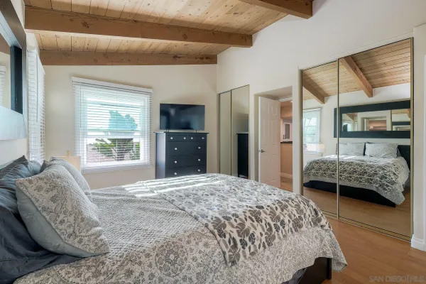 a bedroom with a large bed and a window