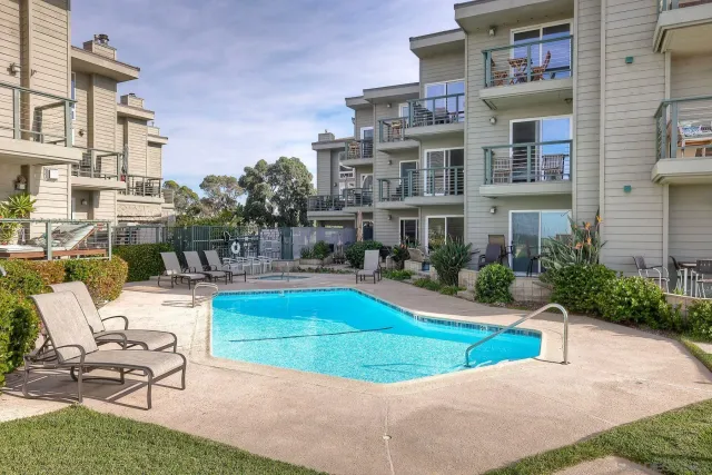 a swimming pool with outdoor seating and yard