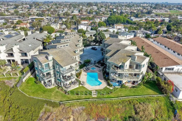 an aerial view of a residential houses with outdoor space