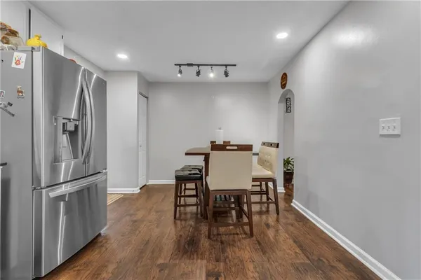 a view of a dining room with furniture a chandelier and wooden floor