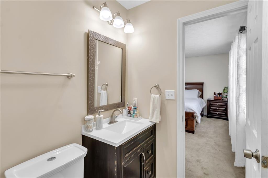3123 Booths Court Dacula, GA 30019 - Photo 23 of 56 a en suite bathroom with a sink a mirror and a shower