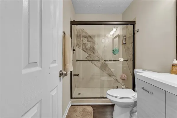 a bathroom with a sink mirror and a toilet