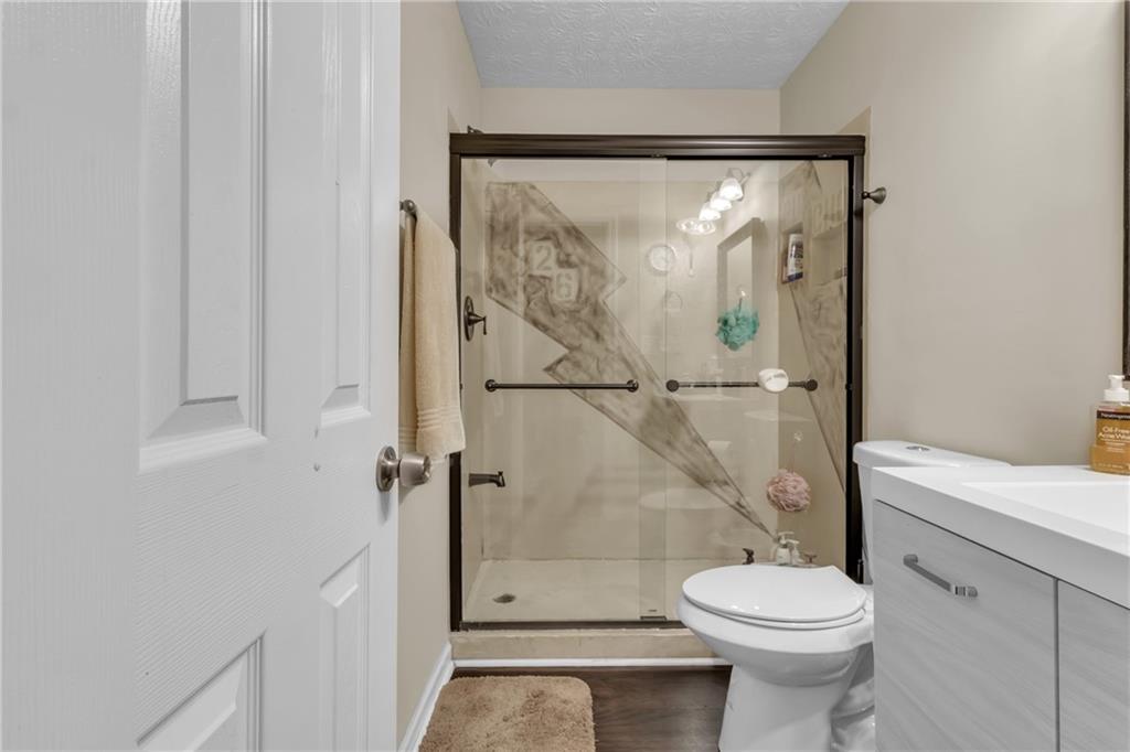 3123 Booths Court Dacula, GA 30019 - Photo 24 of 56 a bathroom with a shower a toilet and a shower