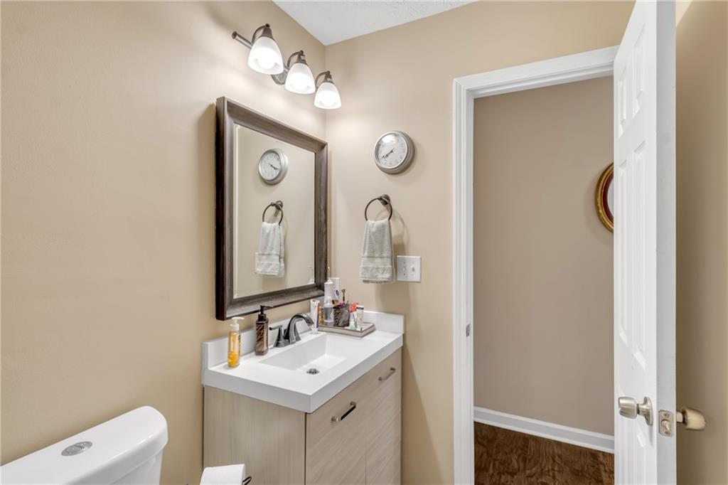 3123 Booths Court Dacula, GA 30019 - Photo 25 of 56 a bathroom with a sink mirror and a toilet